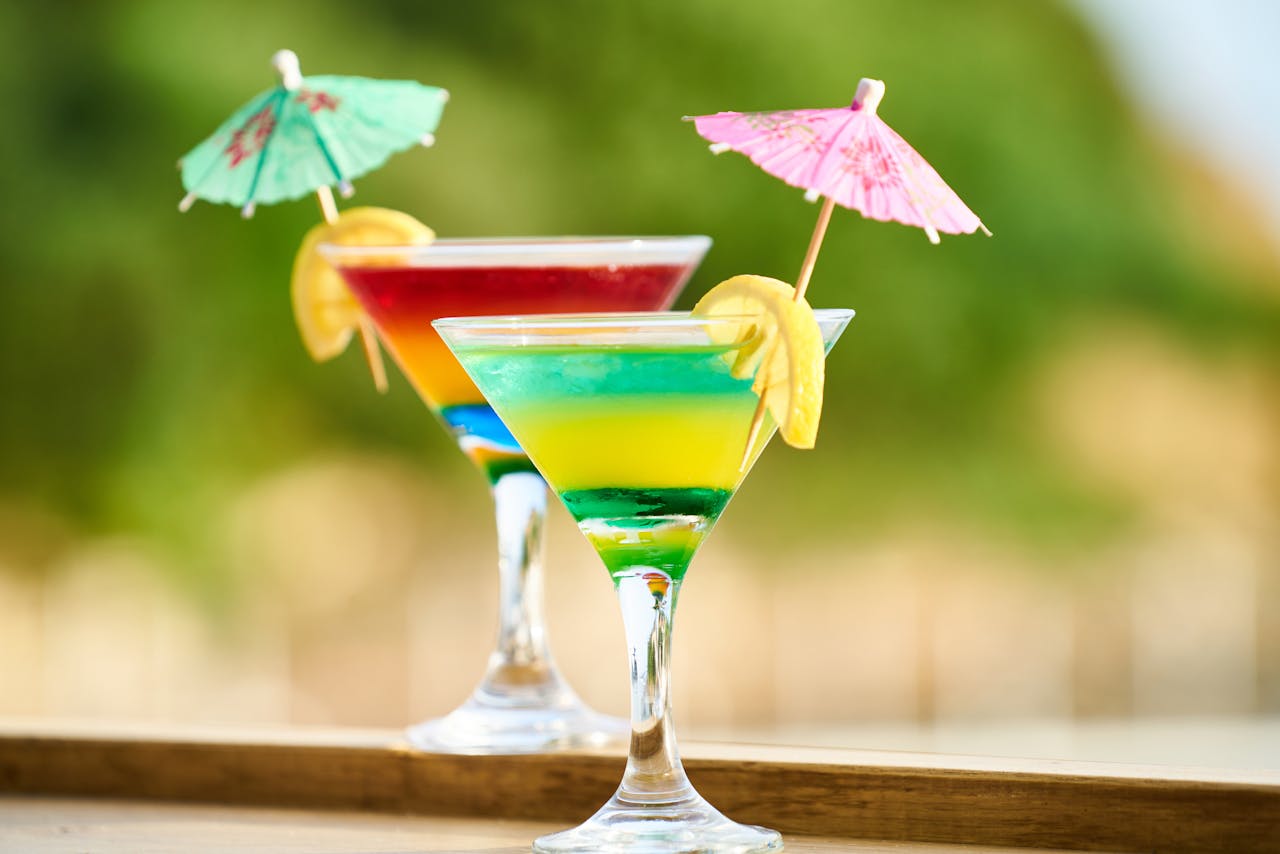 gallery-03 Vibrant cocktails with lemon slices and umbrellas, perfect for summer celebrations.